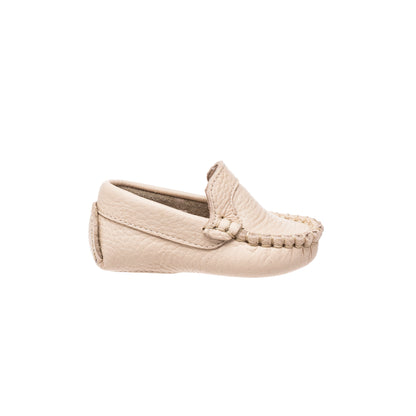 Cream-colored baby moccasin with braided detailing and soft sole.
