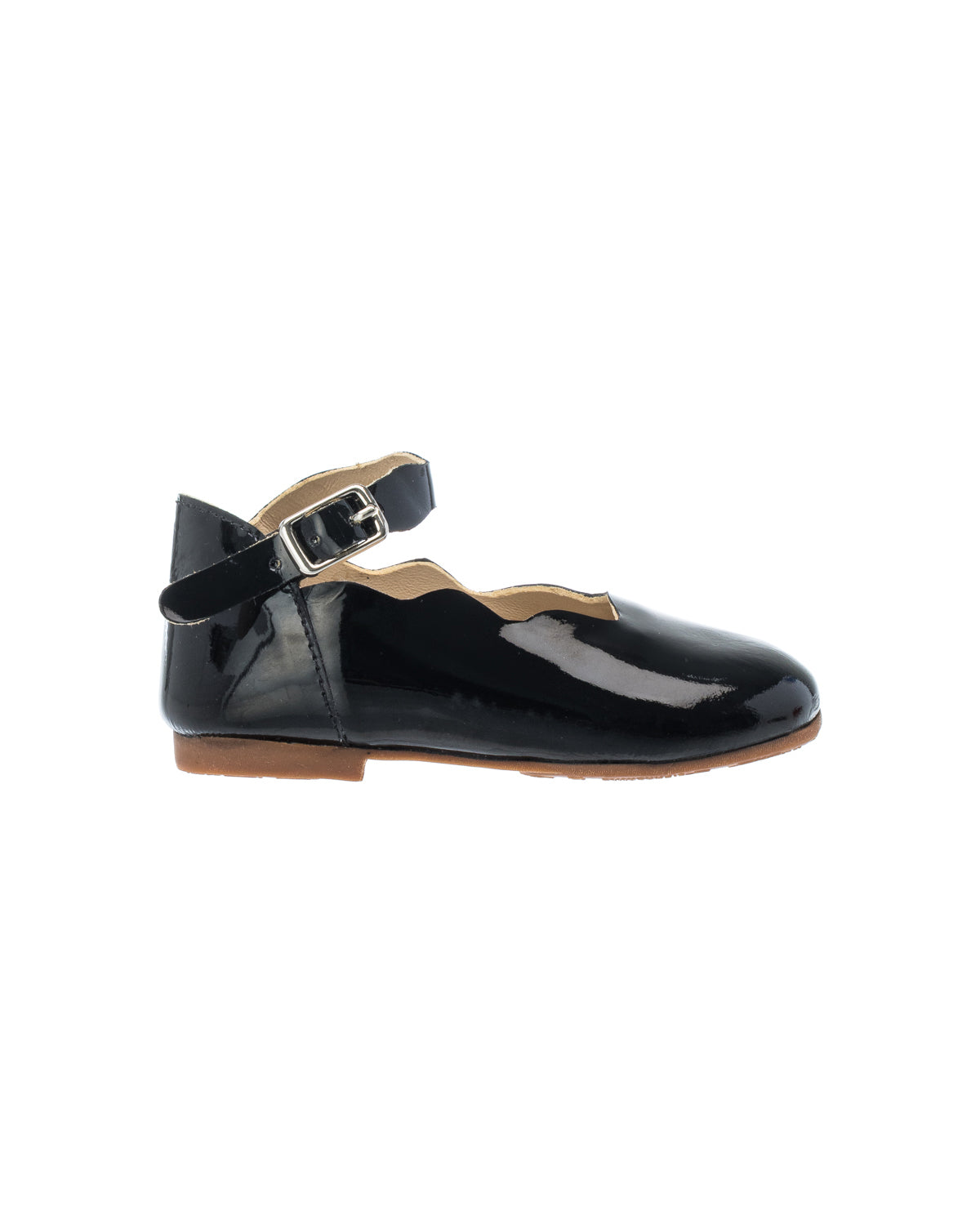 Black patent leather toddler flat with ankle strap and silver buckle, scalloped edges, and brown sole.