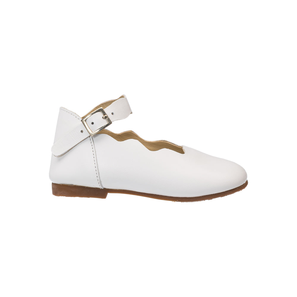 Elephantito - White toddler flat with scalloped edges and ankle strap featuring a silver buckle and brown sole.