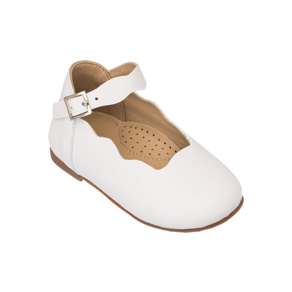 Elephantito - White toddler flat shoe with scalloped edge, adjustable ankle strap, and soft leather material.