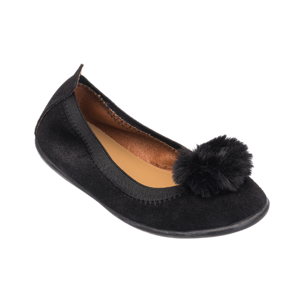 Black suede ballerina shoe with round pom pom on top and rounded toe.