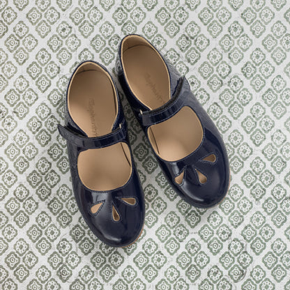 Glossy blue patent leather Mary Jane shoes for girls with teardrop cutouts and adjustable strap.