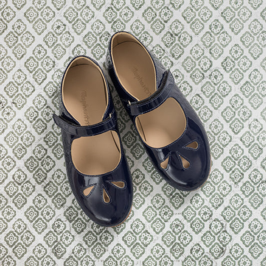 Glossy blue patent leather Mary Jane shoes for girls with teardrop cutouts and adjustable strap.