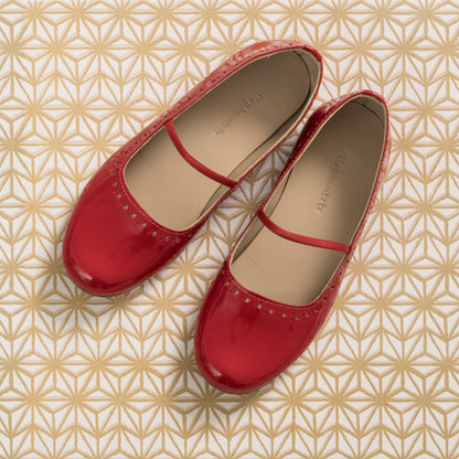 Red patent leather ballerina flats for girls with a thin strap across the top.