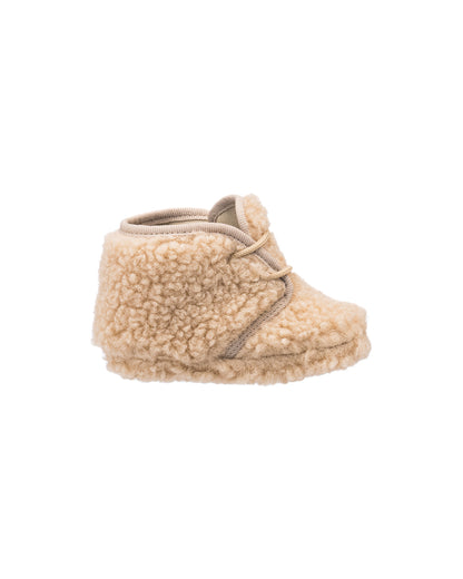 Beige shearling baby bootie with soft, textured fleece and rounded toe design.