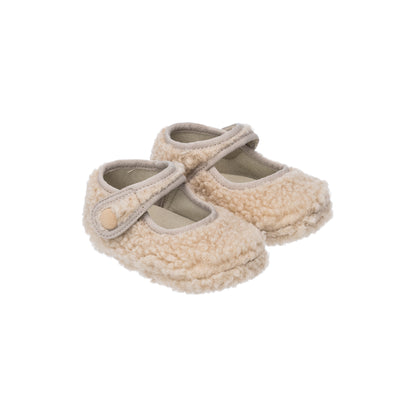 Beige shearling baby Mary Jane shoes with strap and button closure.