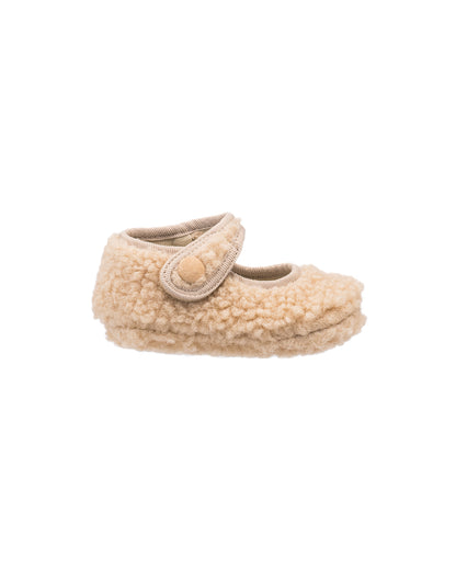 Beige shearling baby Mary Jane shoe with rounded toe and adjustable strap closure.