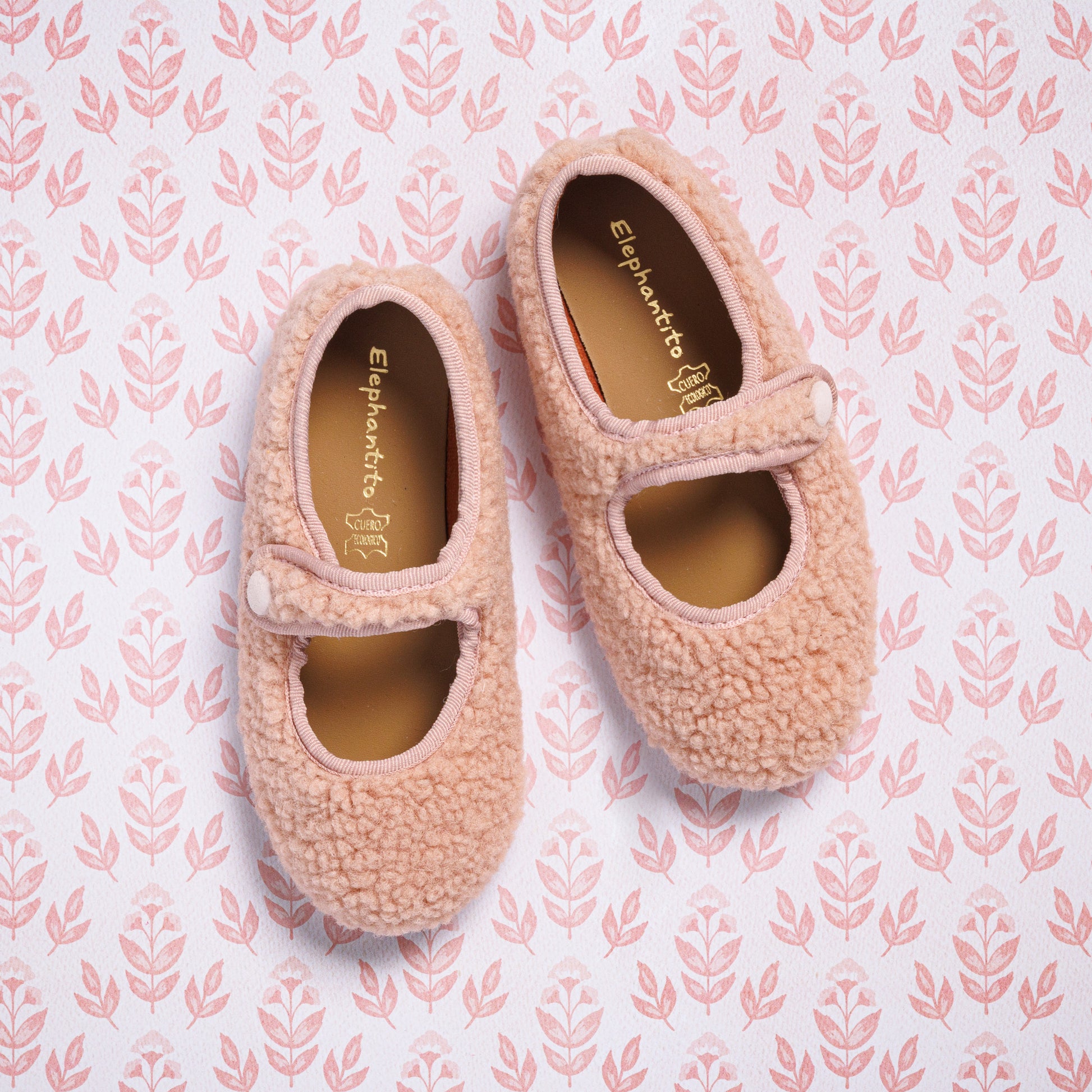 Pink shearling Mary Jane shoes for toddlers with a single strap and rounded toe.