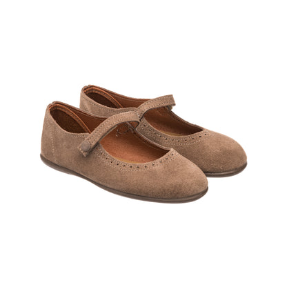 Beige suede Mary Jane shoes for girls with a strap and decorative perforations.