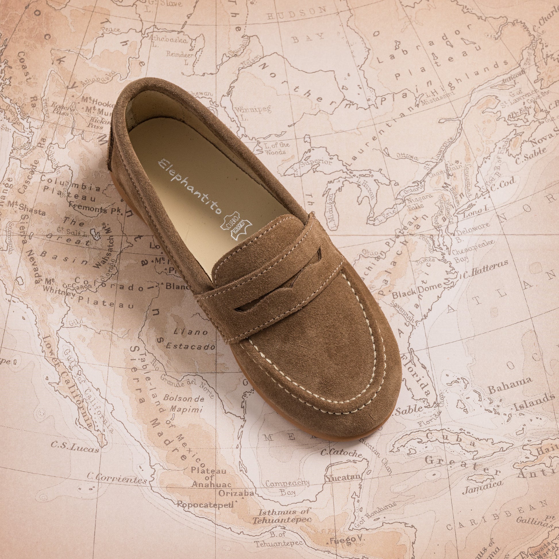 Toffee brown suede penny loafer for toddlers with contrast stitching and a classic moccasin toe design.
