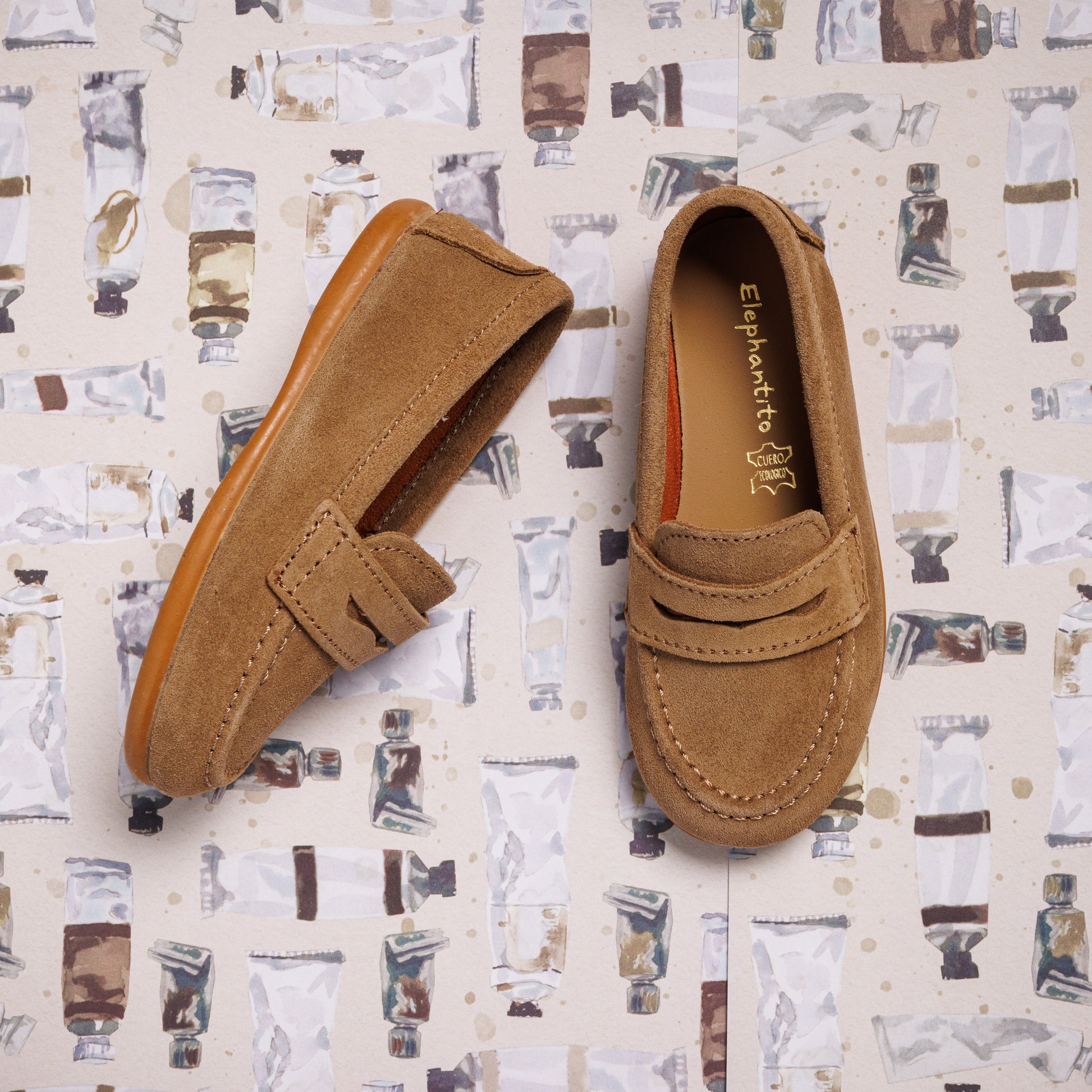 Toffee brown suede penny loafer with stitched moccasin toe and a classic strap detail.