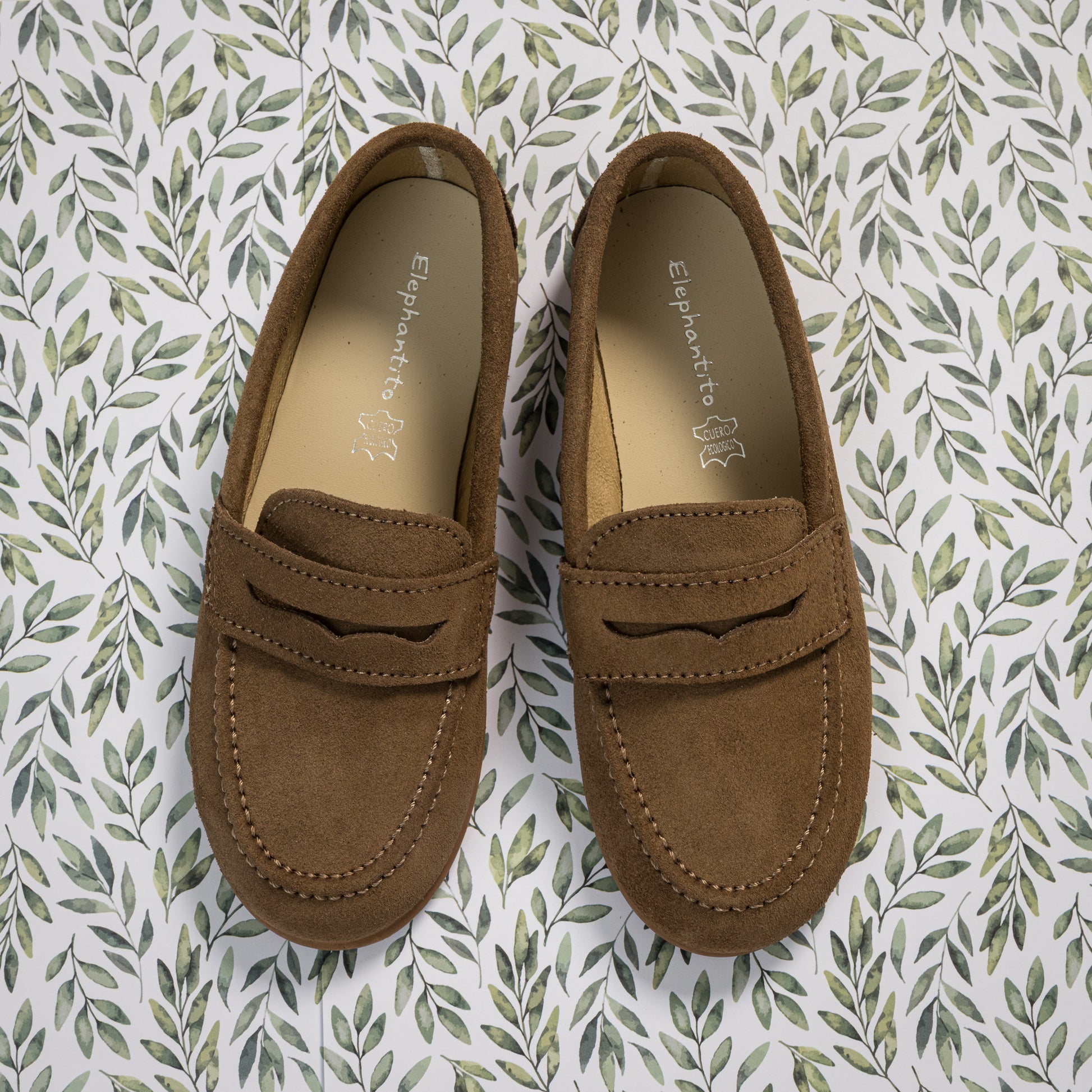 Toffee brown suede penny loafers for boys with classic moccasin stitching and a rounded toe.