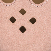 Pink suede shoe with scalloped edge and four diamond-shaped cutouts on top.