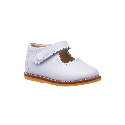 Light blue toddler Mary Jane shoe with scalloped edge strap and tan sole.
