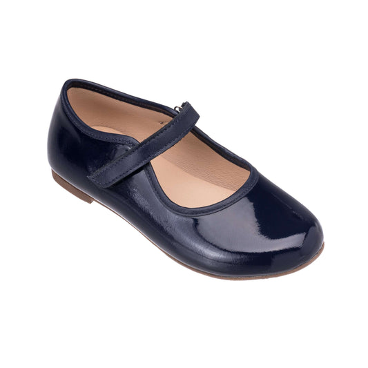Navy patent leather Mary Jane shoe for girls with a single adjustable strap and rounded toe.