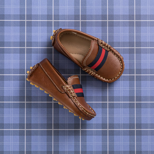 Natural brown toddler loafers with red and navy striped elastic band and soft grips on soles.