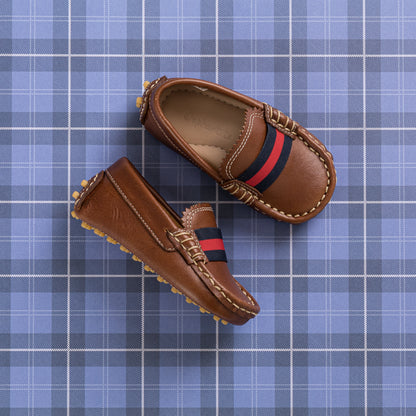 Natural brown toddler loafers with red and navy striped elastic band and soft grips on soles.