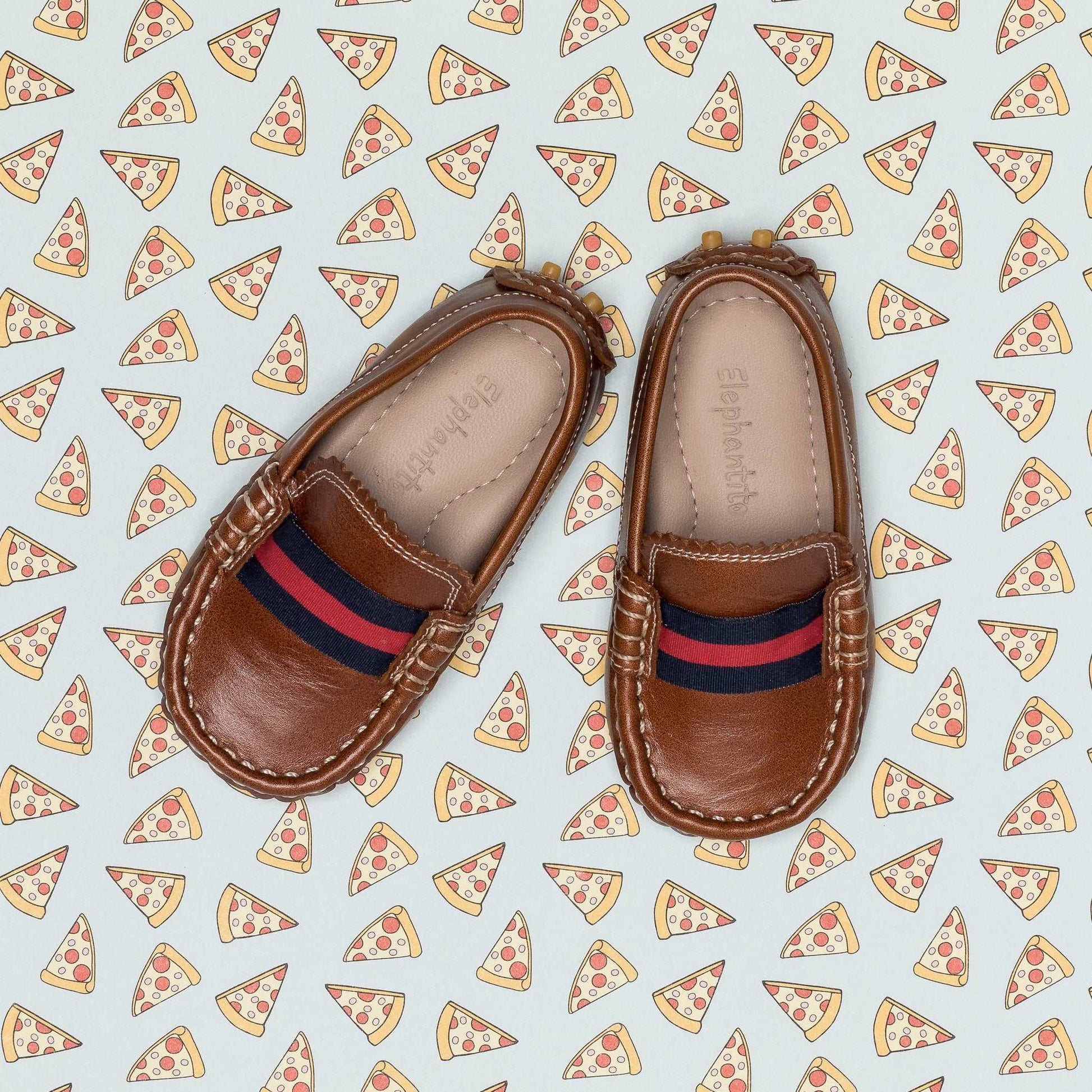 Natural brown toddler loafers with red and navy striped fabric detail and stitched edges.