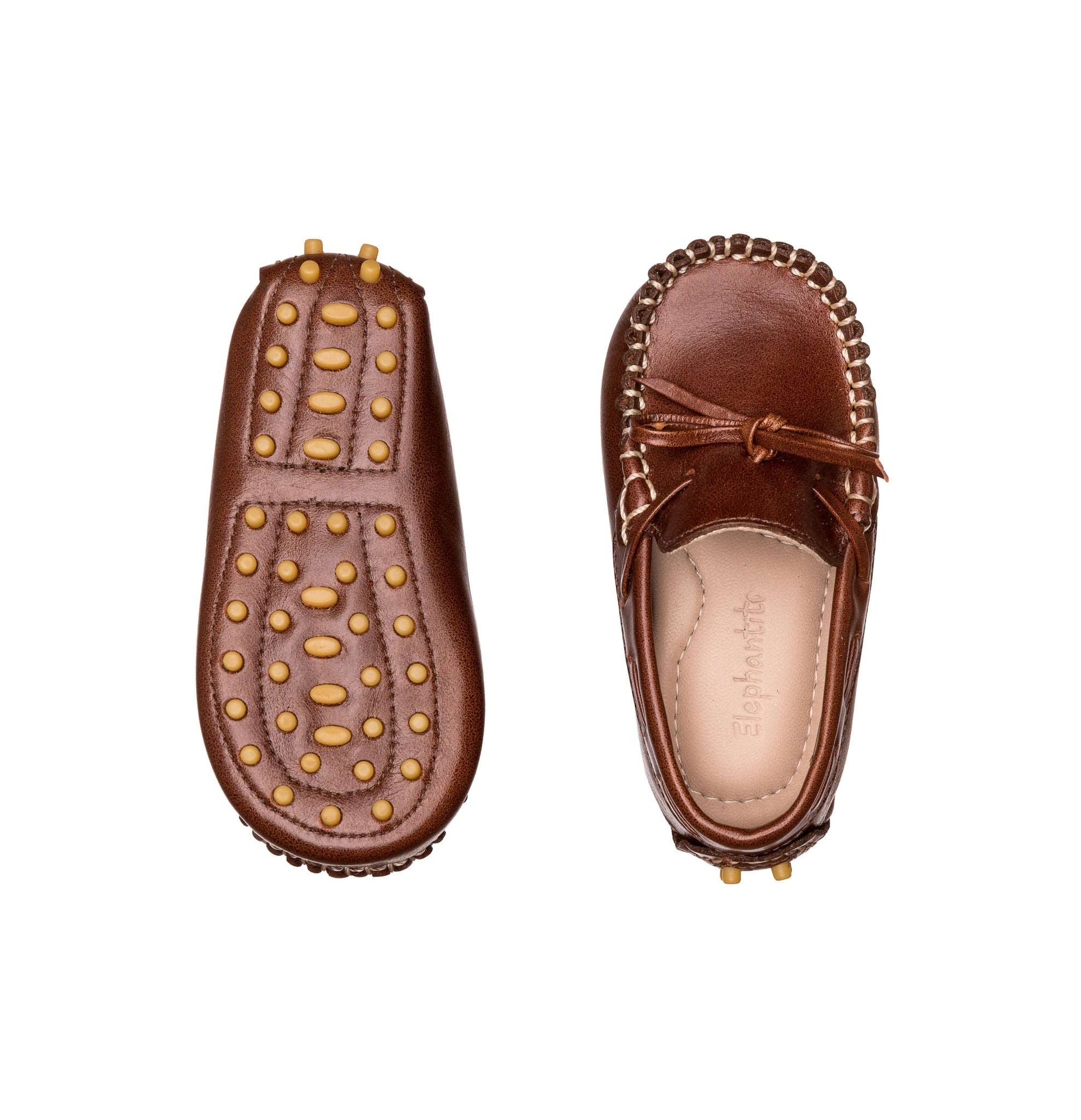 Brown leather baby loafer with moccasin stitching and bow detail, rubber pebble sole visible underneath.