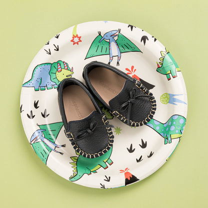Baby navy blue leather driver loafers with bow and moccasin stitching on dinosaur print plate.