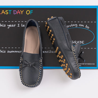 Navy blue leather boys driver loafers with moccasin stitching and rubber pebble sole.