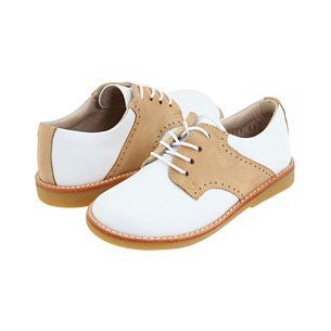 Children's white and ivory leather golf-style shoes with perforated detailing and white laces.