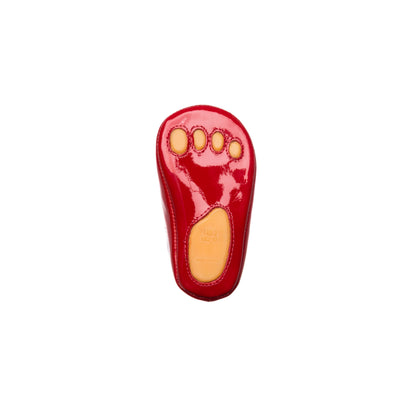 Red patent leather baby Mary Jane shoe with yellow sole and rounded toe.