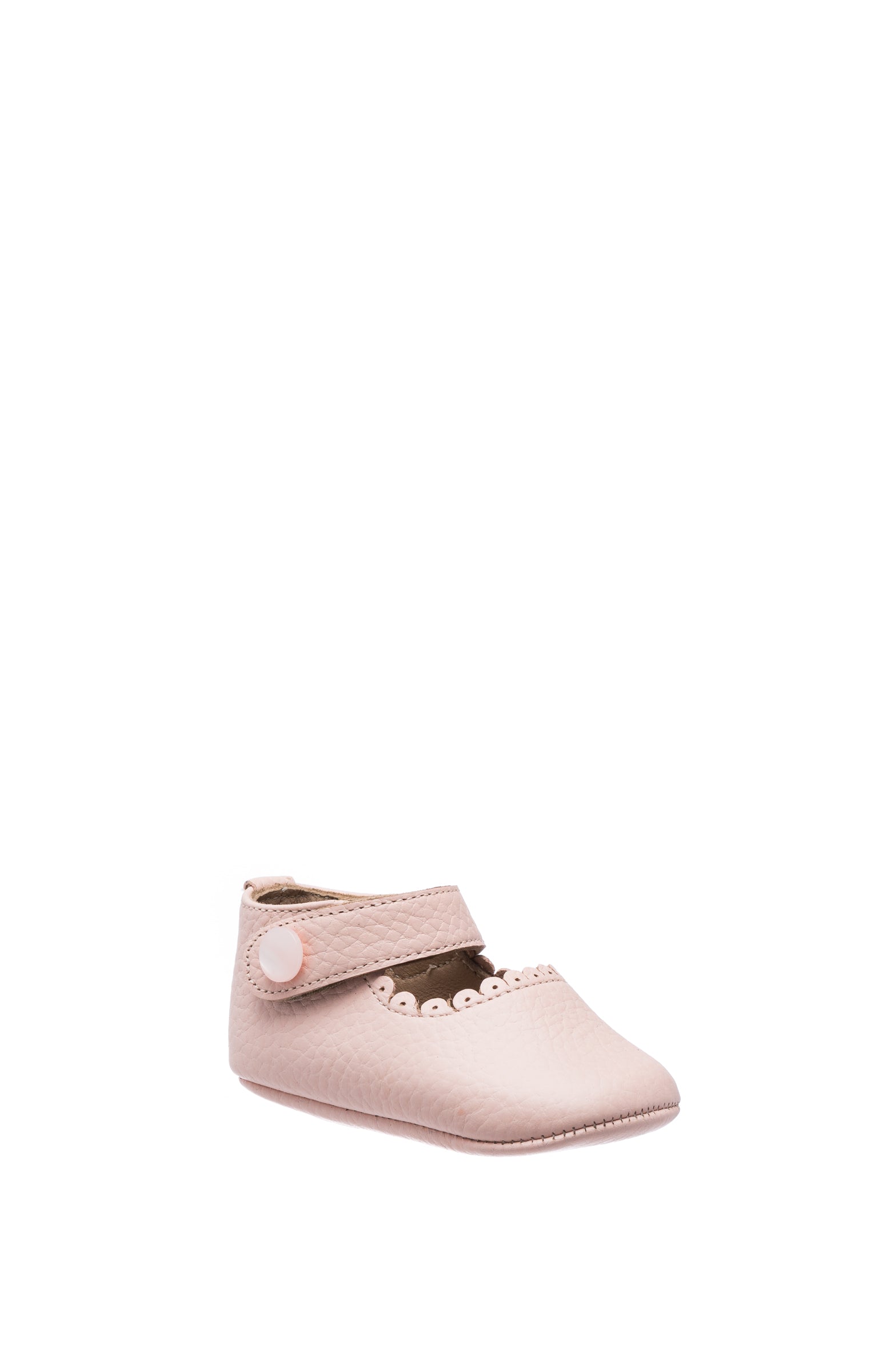 Soft pink baby Mary Jane shoe with scalloped edge and Velcro strap closure.