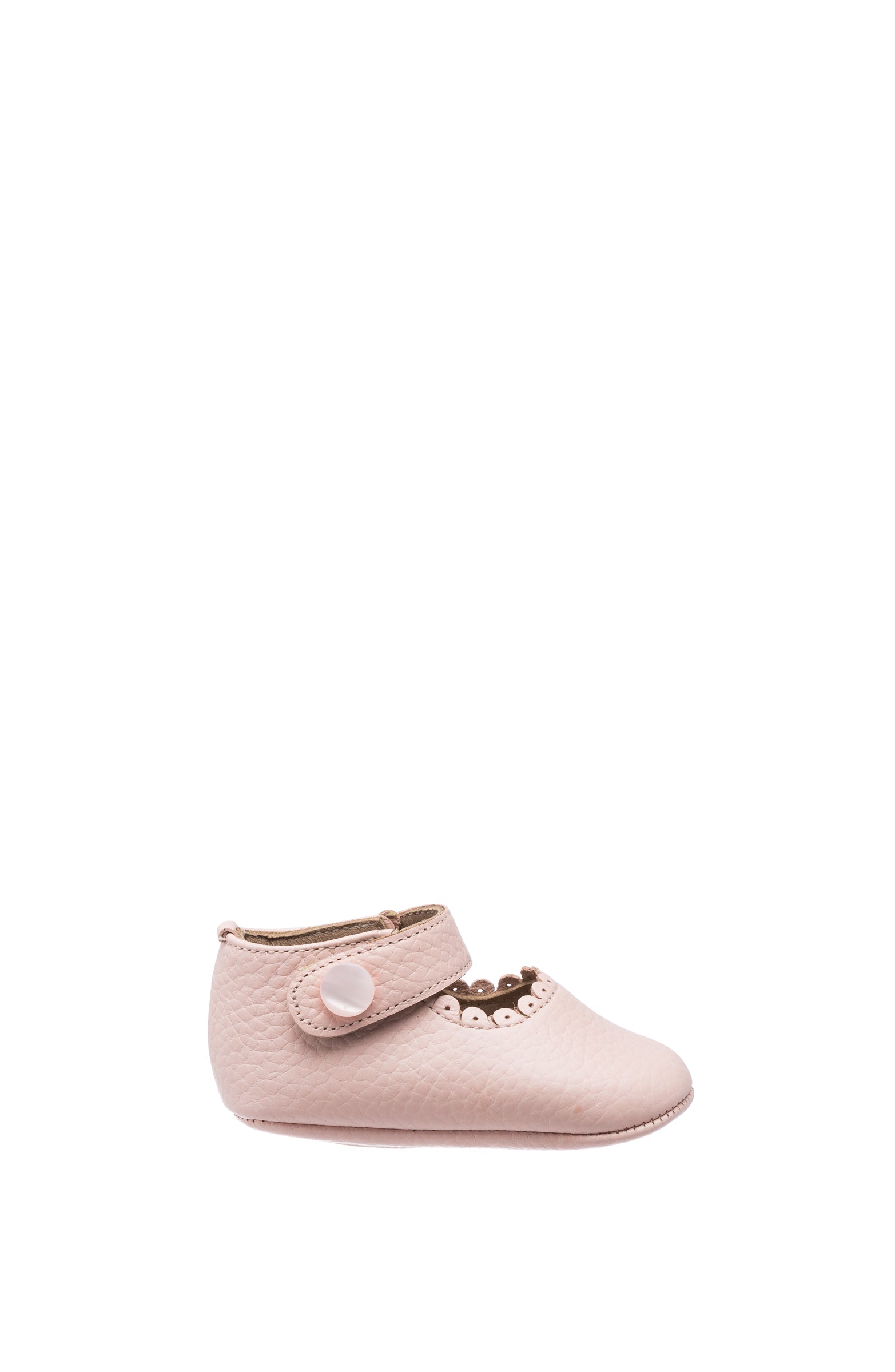 Soft pink baby Mary Jane shoe with a scalloped edge and Velcro strap closure.