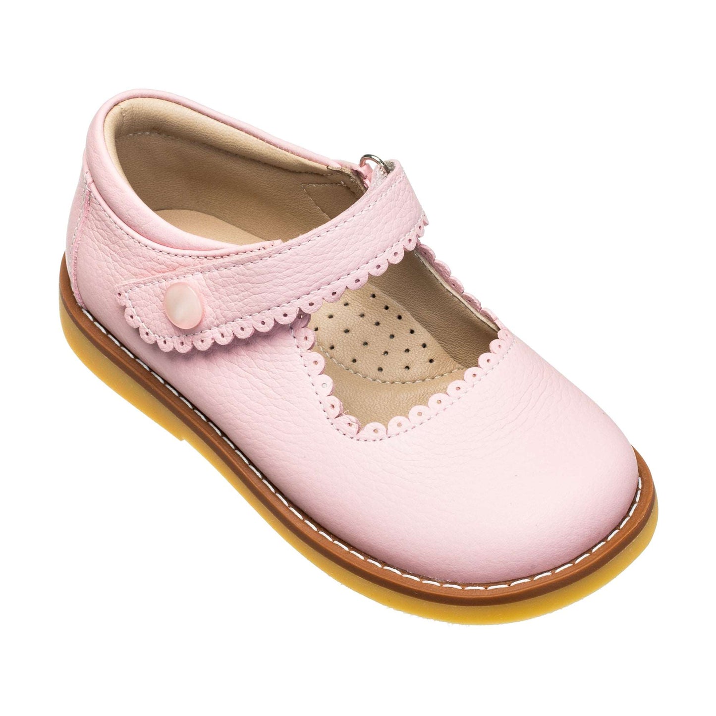 Pink leather Mary Jane shoe for toddlers with scalloped edges and a button strap closure.