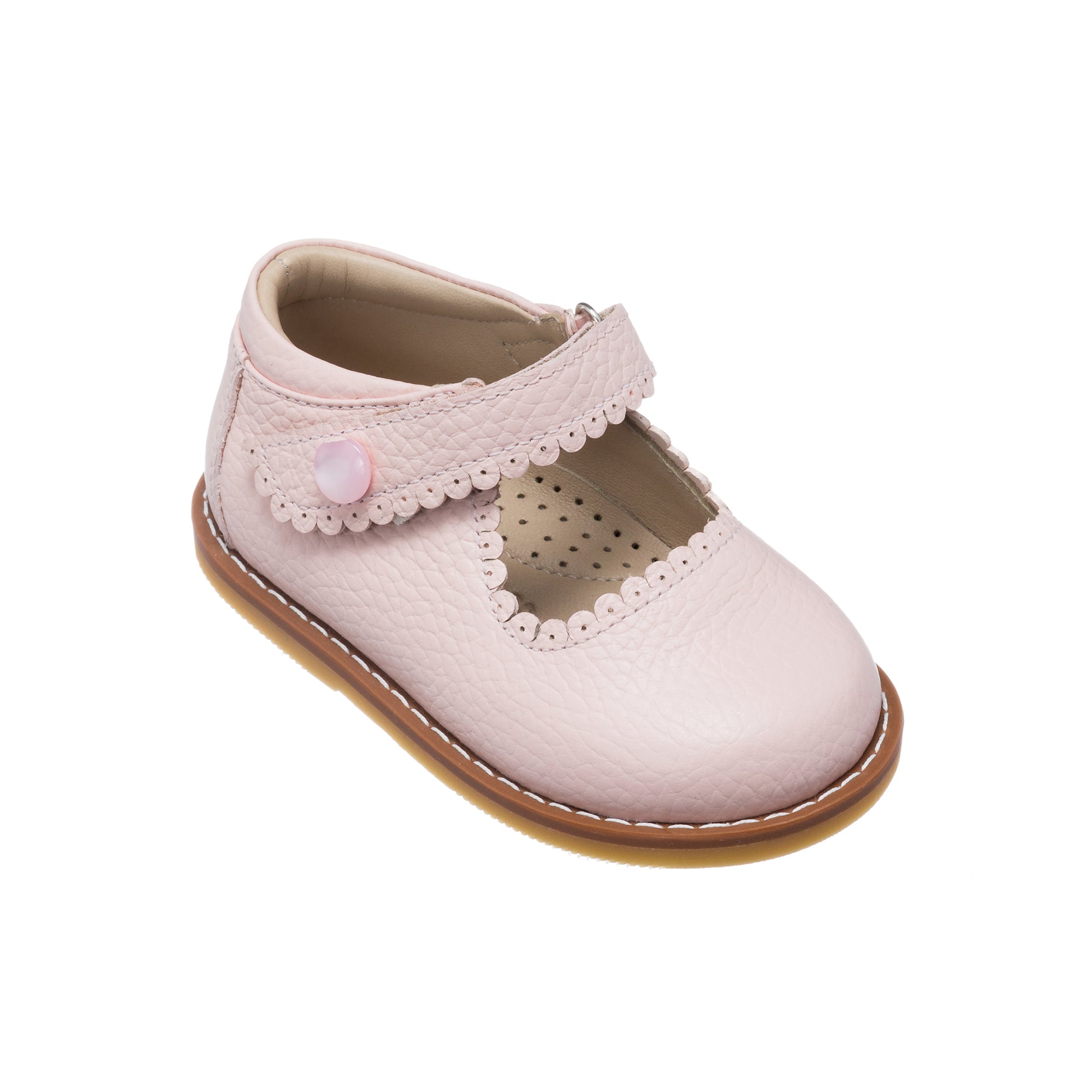 Pink toddler Mary Jane shoe with scalloped strap and button detail, perforated insole, tan sole.